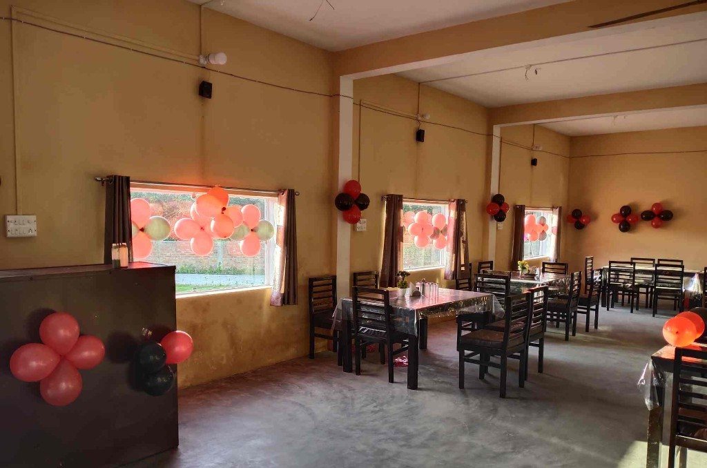 A dining room at Manu Resort set with tables for a gathering