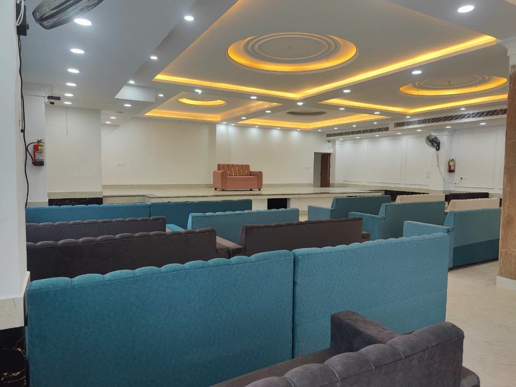 The celebration hall at Manu Resort, with sofas facing a small stage