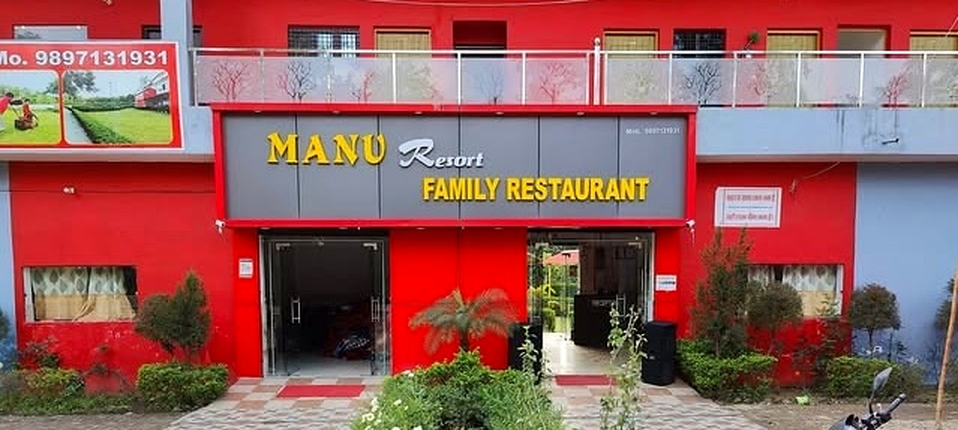 The front of Manu Resort and Family Restaurant, red walls and the yellow sign above the doors
